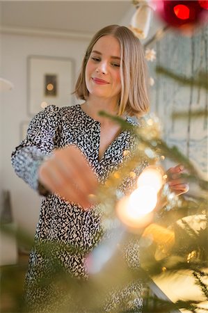 simsearch:6126-08644727,k - Finland, Young woman decorating Christmas tree Stock Photo - Premium Royalty-Free, Code: 6126-08659498