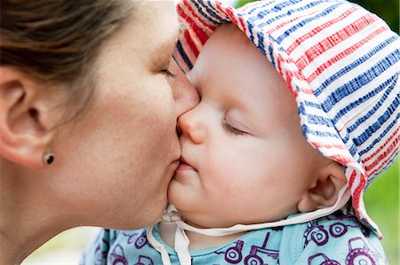 simsearch:6126-08644727,k - Sweden, Bohuslan, Woman kissing her baby daughter (6-11 months) Stock Photo - Premium Royalty-Free, Code: 6126-08635075