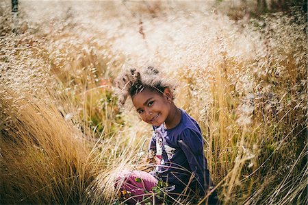 simsearch:6126-08636059,k - Sweden, Medelpad, Sundsvall, Juniskar, Portrait of smiling girl (4-5) sitting in field Stock Photo - Premium Royalty-Free, Code: 6126-08635221