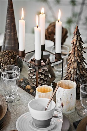 Sweden, Cup and saucer and candles on table during Christmas Stock Photo - Premium Royalty-Free, Code: 6126-08635351