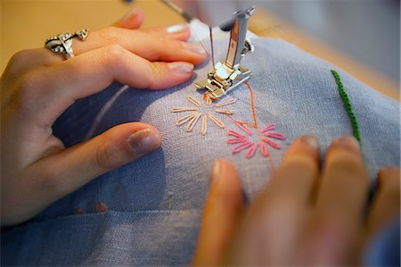 Sweden, Uppland, Norrmalm, Close up of girl (14-15) stitching on sewing machine Stock Photo - Premium Royalty-Free, Code: 6126-08635311