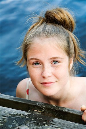 freckled girl - Sweden, Dalarna, Portrait of teenage girl (16-17) swimming in lake Stock Photo - Premium Royalty-Free, Code: 6126-08635502