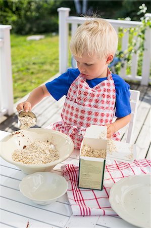 Sweden, Stockholm Archipelago, Grasko, Boy (4-5) cooking outdoors Stock Photo - Premium Royalty-Free, Code: 6126-08635923