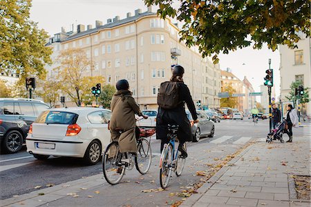 Sweden, Uppland, Stockholm, Vasatan, Torsgatan, Man and woman cycling on city street Stock Photo - Premium Royalty-Free, Code: 6126-08636178