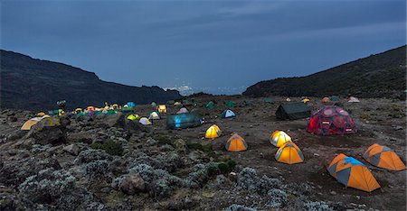 Tanzania, Kilimanjaro, Lemosho Route, Tent camp in mountains at dawn Stock Photo - Premium Royalty-Free, Code: 6126-08636421