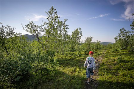 simsearch:6126-08636059,k - Sweden, Lapland, Kiruna, Rear view of boy (10-11) hiking Stock Photo - Premium Royalty-Free, Code: 6126-08636568