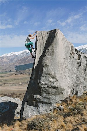 simsearch:6118-09039107,k - New Zealand, Castle Hill, Young man climbing up steep rockface Stock Photo - Premium Royalty-Free, Code: 6126-08636703