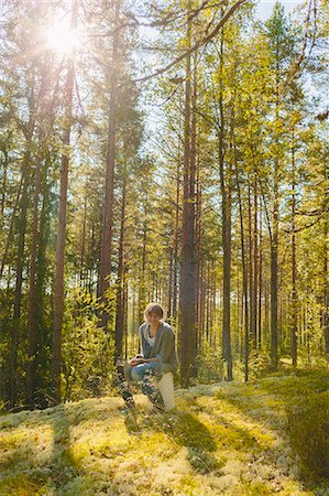 pinus - Finland, Etela-Savo, Huttula, Young woman sitting on bucket in forest Stock Photo - Premium Royalty-Free, Code: 6126-08636717