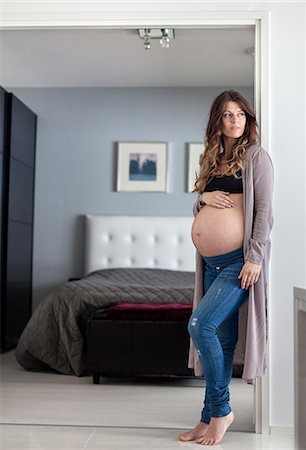Finland, Pregnant woman standing in doorway Stock Photo - Premium Royalty-Free, Code: 6126-08636735