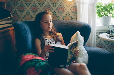 Sweden, Smaland, Mortfors, Portrait of reading girl (10-11) Stock Photo - Premium Royalty-Free, Code: 6126-08781437