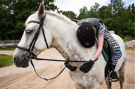 reins - A young girl hugging her horse Stock Photo - Premium Royalty-Free, Code: 6126-09102403