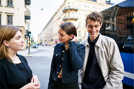 Young people standing in street talking Stock Photo - Premium Royalty-Free, Code: 6126-09102414