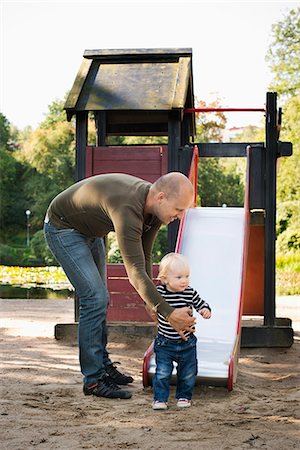 simsearch:6116-07236010,k - Stay at home dad playing with baby son Stock Photo - Premium Royalty-Free, Code: 6126-09102594