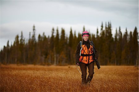 Female hunter walking in field Stock Photo - Premium Royalty-Free, Code: 6126-09102536