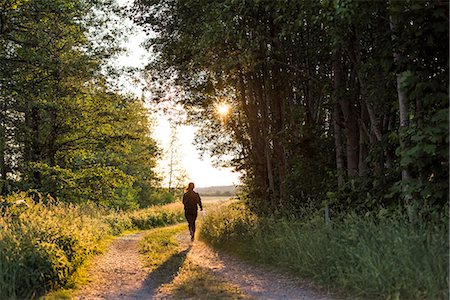 Teenage girl jogging in forest Stock Photo - Premium Royalty-Free, Code: 6126-09102668