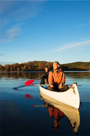 simsearch:6126-08643505,k - Two men paddling boat on lake Stock Photo - Premium Royalty-Free, Code: 6126-09102801