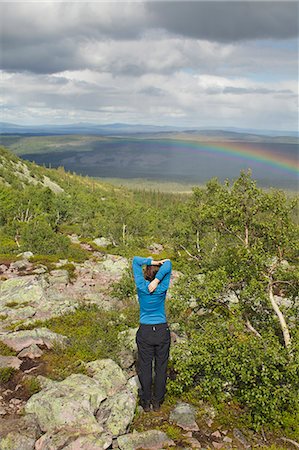 simsearch:6126-08643505,k - Man standing on hill and looking at landscape with rainbow Stock Photo - Premium Royalty-Free, Code: 6126-09102811