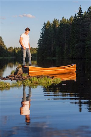 simsearch:6126-08643505,k - Man standing on boulder in middle of lake Stock Photo - Premium Royalty-Free, Code: 6126-09103109