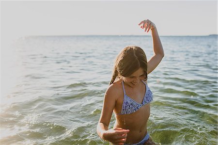 A young girl swimming in the sea Stock Photo - Premium Royalty-Free, Code: 6126-09103548