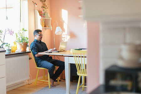 female on a radiator - Man using laptop at dining table Photographie de stock - Premium Libres de Droits, Code: 6126-09267270