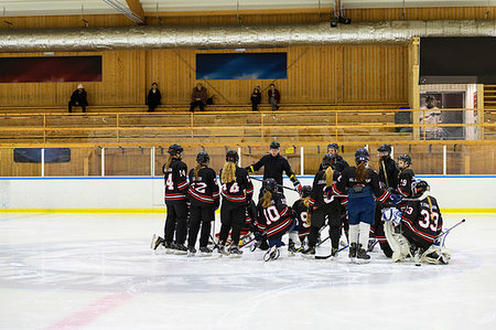 Girls listening to their coach during ice hockey training Stock Photo - Premium Royalty-Free, Code: 6126-09268049