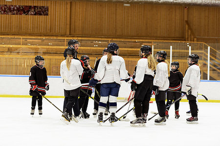 Girls listening to their coach during ice hockey training Stock Photo - Premium Royalty-Free, Code: 6126-09268060