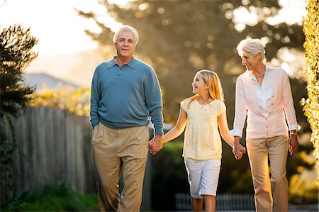 simsearch:6128-08738334,k - Mature couple walking hand in hand with their young granddaughter. Stock Photo - Premium Royalty-Free, Code: 6128-08747741