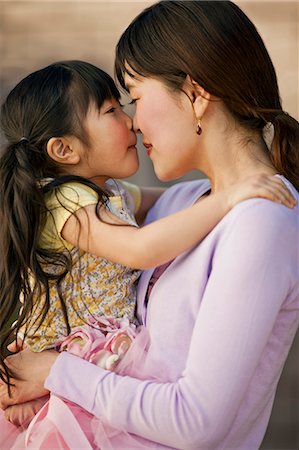 flower for mom asian - Mother and daughter touching noses. Stock Photo - Premium Royalty-Free, Code: 6128-08747736