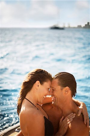 simsearch:6128-08738334,k - Happy mid-adult couple hugging on the deck of a boat. Stock Photo - Premium Royalty-Free, Code: 6128-08747894