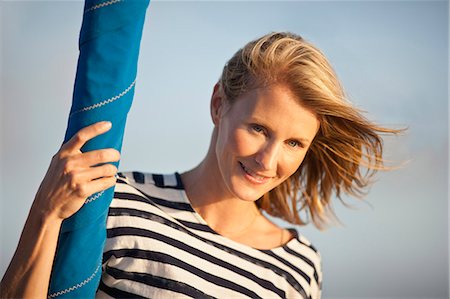 Portrait of mid-adult woman outside with wind-swept hair. Stock Photo - Premium Royalty-Free, Code: 6128-08748046