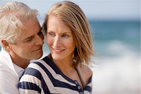 simsearch:6128-08738334,k - Mid adult woman being affectionate with her husband on the beach. Stock Photo - Premium Royalty-Free, Code: 6128-08748073