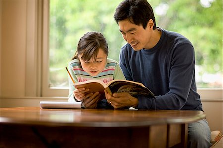 Father helping his daughter with her homework. Stock Photo - Premium Royalty-Free, Code: 6128-08766946