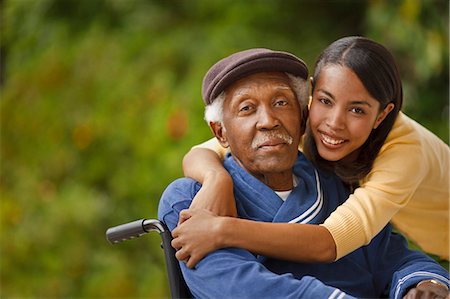 Portrait of elderly man in a wheelchair with his daughter. Stock Photo - Premium Royalty-Free, Code: 6128-08766919