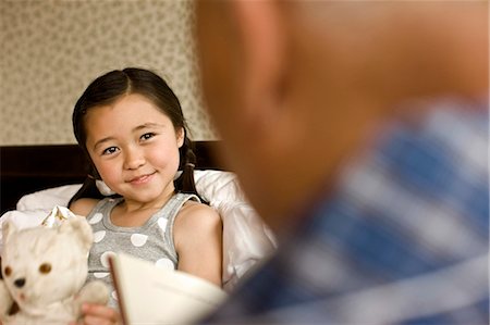 ethnic kids back of head - Grandfather reads to his granddaughter while she is ill in bed. Stock Photo - Premium Royalty-Free, Code: 6128-08766939