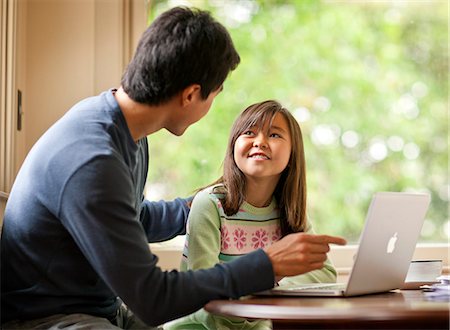 simsearch:400-05749563,k - Mid adult man and his young daughter using a laptop computer. Stock Photo - Premium Royalty-Free, Code: 6128-08767042