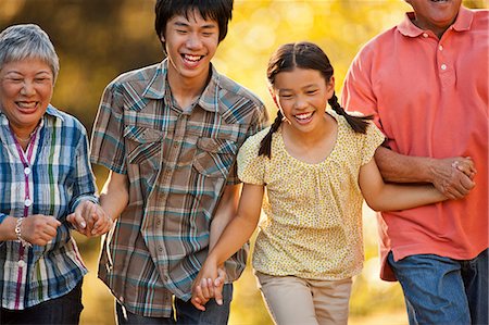 Happy children walking hand in hand with their grandparents. Stock Photo - Premium Royalty-Free, Code: 6128-08767174