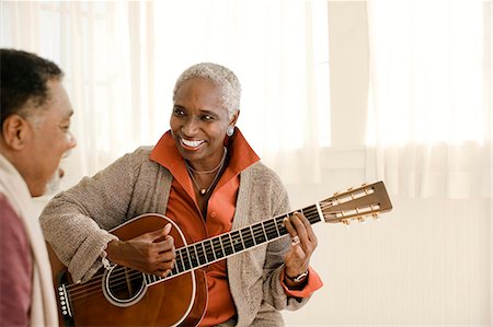 elderly african american male - Happy senior man teaching his wife how to play guitar. Stock Photo - Premium Royalty-Free, Code: 6128-08767257