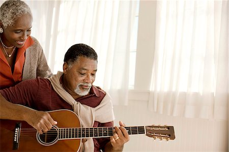 elderly african american male - Smiling senior woman listening to her husband play an acoustic guitar. Stock Photo - Premium Royalty-Free, Code: 6128-08767263