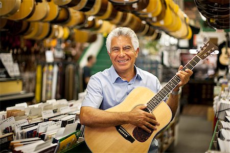 simsearch:649-07063808,k - Portrait of a smiling senior man playing an acoustic guitar. Stock Photo - Premium Royalty-Free, Code: 6128-08767273