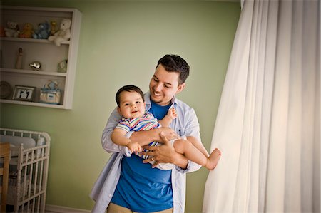 simsearch:700-06758135,k - Portrait of a toddler being held by his young adult father. Stock Photo - Premium Royalty-Free, Code: 6128-08780400