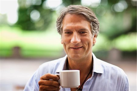Portrait of a mature man outdoors drinking a cup of coffee. Stock Photo - Premium Royalty-Free, Code: 6128-08780781