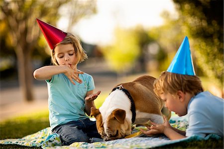 simsearch:673-03826592,k - Bulldog eating birthday cake off a plate, with horrified young boy looking on. Stock Photo - Premium Royalty-Free, Code: 6128-08780850