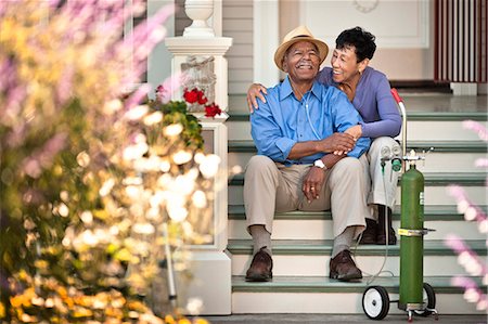 elderly african american male - Senior woman sitting on the staircase and hugging her happy husband with nasal tubes. Stock Photo - Premium Royalty-Free, Code: 6128-08780951