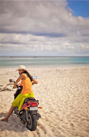scooter rear view - Smiling young woman having fun on a moped scooter at a tropical beach. Stock Photo - Premium Royalty-Free, Code: 6128-08798783