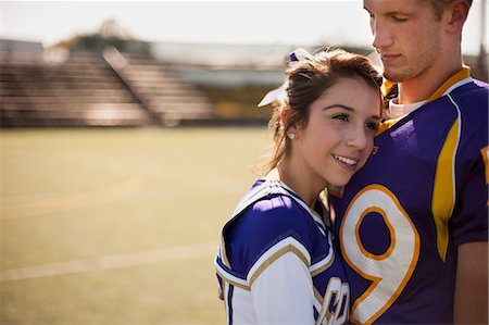 football stadium not soccer - Cheerleader snuggled into football player's chest. Stock Photo - Premium Royalty-Free, Code: 6128-08799091