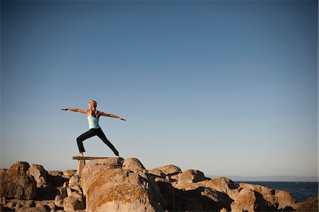 simsearch:633-01714467,k - Woman doing yoga on the rocks of the beach. Stock Photo - Premium Royalty-Free, Code: 6128-08799094