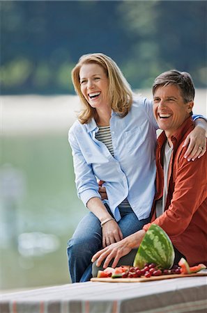 simsearch:6128-08738334,k - Happy middle aged couple enjoying a healthy fruit picnic in the park. Stock Photo - Premium Royalty-Free, Code: 6128-08799026