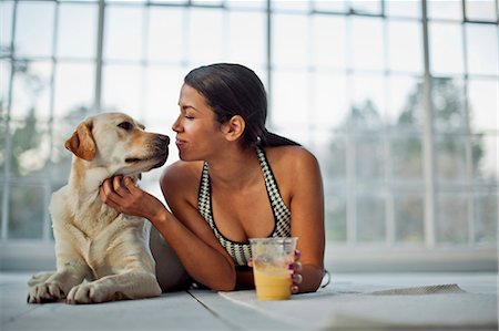 dog and woman and love - Young woman nuzzling her dog, while rehydrating with a juice. Stock Photo - Premium Royalty-Free, Code: 6128-08727588