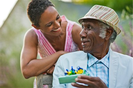 elderly african american male - Happy senior man smiling at his adult daughter after receiving a birthday gift. Stock Photo - Premium Royalty-Free, Code: 6128-08727744