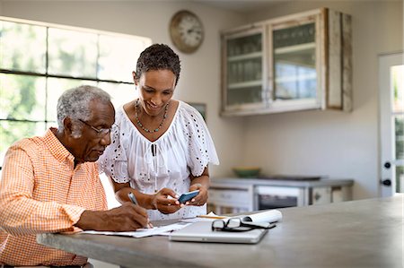 depth of field - Husband and wife do taxes together. Stock Photo - Premium Royalty-Free, Code: 6128-08727770